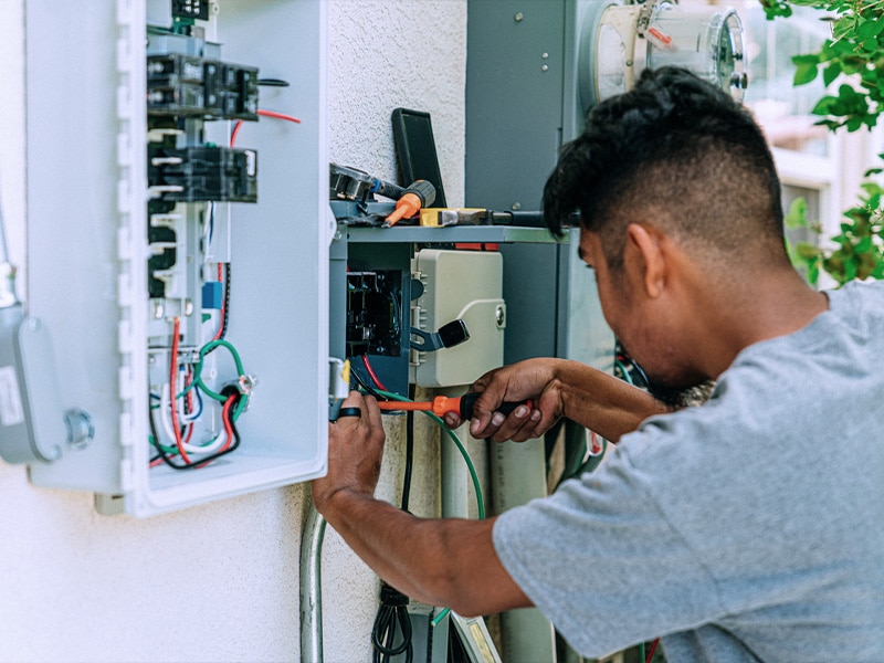Electrician working on main panel