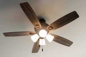 Licensed electrician installing a ceiling fan