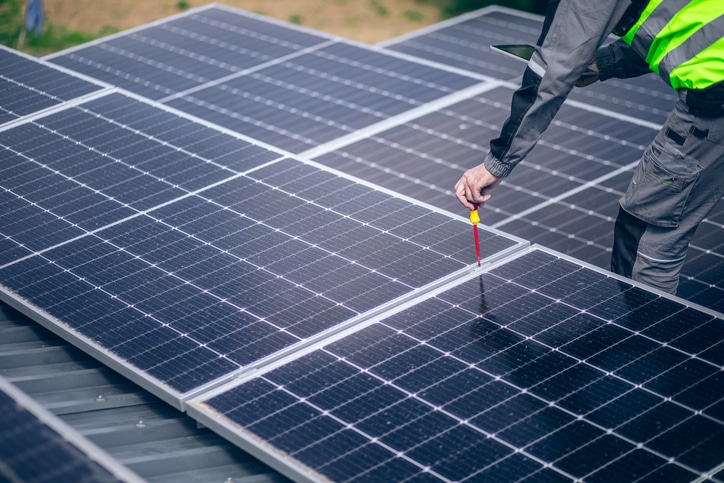 California homeowner reviewing energy savings from solar battery storage system on tablet
