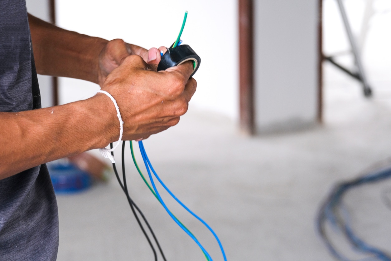 Electrician performing house rewiring work to replace outdated wiring and improve home safety in Murrieta CA